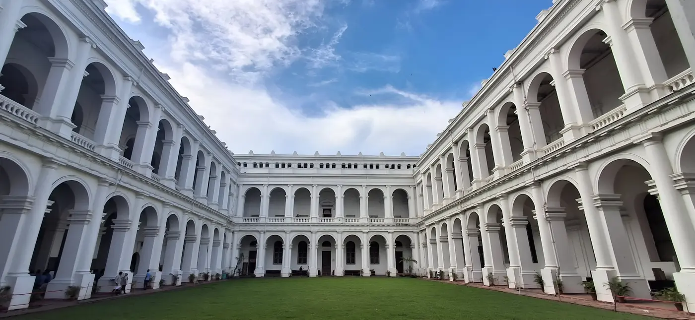 Arched walkways around a courtyard at an Indian university