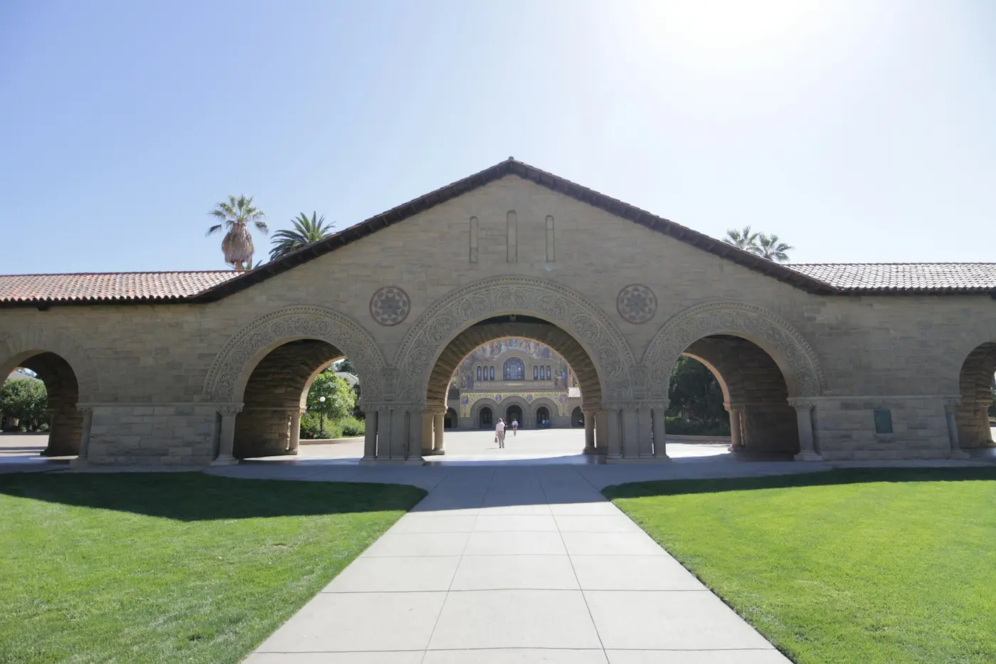 A stone archway leading into a university courtyard